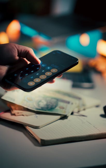 Asmuo su mobiliuoju telefonu įrašo dienos išlaidas biudžeto sekimui